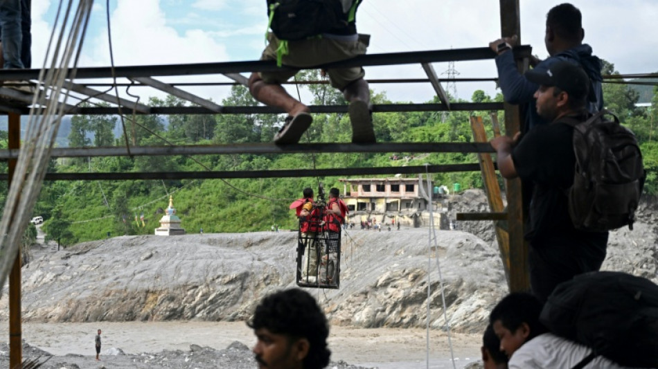 Nepal flood survivors cling to zipline to cross treacherous river