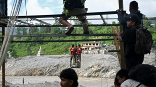 Nepal flood survivors cling to zipline to cross treacherous river